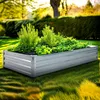 A raised garden bed filled with lush green plants sits in a sunny garden. Produktbild-Vorschau