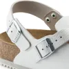 A close-up view of a white Birkenstock sandal, focusing on the buckle and straps. Produktbild-Vorschau