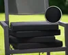 A stack of black chair cushions on a chair outdoors. Produktbild-Vorschau