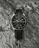 A black Casio watch with a leather strap is displayed on a textured gray and black surface. Anteprima dell’immagine prodotto