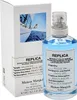 A bottle of Maison Margiela Replica Sailing Day Eau de Toilette and its packaging are displayed. Voir les images du produit