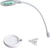 A white LED magnifying lamp with a flexible gooseneck arm and a clip base, shown with a separate circular base and a clip accessory. Produktbild-Vorschau