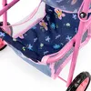 A close-up view of the interior and frame of a pink toy doll stroller with a blue fabric lining featuring a floral and butterfly pattern. Produktbild-Vorschau