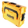 A bright orange tool case with black accents and handles, featuring the brand name "REMS" and the tagline "for Professionals" printed on the front. Voir les images du produit