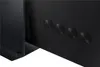 Close-up of the back of a black television, showing four circular speaker grilles. Produktbild-Vorschau