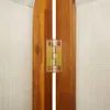A close-up view of a hinge connecting two wooden panels, with beige fabric visible on the sides. Voir les images du produit