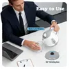 A man in a suit pouring water from a kettle into a glass on a desk with a laptop. Produktbild-Vorschau