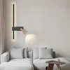 A modern living room with a sectional sofa and a wall-mounted lamp. Anteprima dell’immagine prodotto