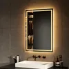 A modern bathroom with a sink, faucet, and a lit mirror. Produktbild-Vorschau