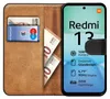 A book-style phone case with cards and money inside, next to a phone displaying product features. Produktbild-Vorschau