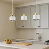 A kitchen scene with three pendant lights hanging above a countertop. Náhled obrázku produktu