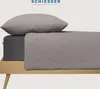 A bed with a pillow and a fitted sheet. Produktbild-Vorschau