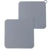 Two square silicone drain covers are shown against a white background. One is in the foreground, and the other is slightly behind and to the right. Produktbild-Vorschau