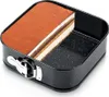 A slice of tiramisu cake sits in a black square springform pan. Anteprima dell’immagine prodotto