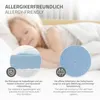 A child sleeping on a bed with close-up insets showing mattress material and texture. Produktbild-Vorschau