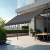 An outdoor patio with a dining set and a retractable awning. Náhled obrázku produktu