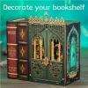 A decorative book nook placed between two faux books on a wooden surface, with a teal and green gradient background. Náhled obrázku produktu