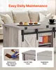 A close-up of a rustic coffee table with sliding barn doors, placed in a living room setting. Produktbild-Vorschau