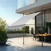 An outdoor patio with a dining table and chairs, shaded by a retractable awning. Produktbild-Vorschau