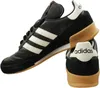 A pair of black Adidas sneakers with white stripes and tan soles, shown from a side and back angle against a white background. Náhled obrázku produktu