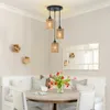 A dining area with a round table, bench seating, and a pendant light fixture. Produktbild-Vorschau