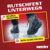 A person wearing shoes with spikes on ice. Produktbild-Vorschau