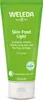 A product shot of a green tube of Weleda Skin Food Light moisturizer on a white background. Voir les images du produit