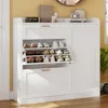 A white shoe cabinet with multiple shelves and drawers, filled with shoes, is shown in a room with yellow walls. Produktbild-Vorschau