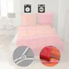 A bed with bedding, a bedside table with a lamp, and icons indicating washing instructions. Produktbild-Vorschau