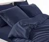 A close-up view of dark blue bedding, including pillows and a duvet, neatly arranged on a bed. Anteprima dell’immagine prodotto