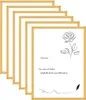 A stack of gold picture frames with a drawing of a rose and text on the front frame. Produktbild-Vorschau