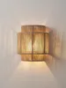 A wall-mounted lamp made of jute rope, emitting a warm glow. Voir les images du produit