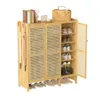 A light brown bamboo shoe cabinet with a woven cane design on the doors, displaying various shoes and accessories. Podgląd zdjęcia produktu