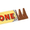 A close-up shot of a Toblerone chocolate bar, partially unwrapped, showing the iconic triangular shape of the chocolate. Anteprima dell’immagine prodotto