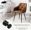 A brown leather chair with black metal legs is shown in a room with a white desk and a rug. Produktbild-Vorschau