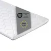 A close-up, angled view of a white mattress topper with a grey label indicating certifications and origin. Produktbild-Vorschau