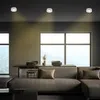 A modern living room with a large window, a sofa, and a table. Produktbild-Vorschau
