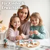 A mother and her two daughters are baking cookies together, with cookie cutters and star-shaped cookies visible on the table. Produktbild-Vorschau