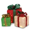 Three illuminated Christmas gift boxes with bows and pinecones, arranged together. Podgląd zdjęcia produktu