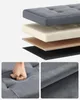 A sectional view of a padded furniture item, with close-up details of its texture and a hand pressing down on it. Produktbild-Vorschau