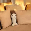 A plush toy penis is placed on a couch surrounded by pillows. Náhled obrázku produktu