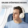 A man wearing headphones sits in an airplane seat, looking out the window. Produktbild-Vorschau