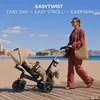 A woman pushing a stroller on a beach boardwalk. Produktbild-Vorschau