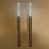 Two solar-powered light posts with clear tubes containing air bubbles, standing against a plain background. Produktbild-Vorschau