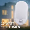 A white LED outdoor light with a motion sensor is shown in front of a blurred house at dusk. Text indicates the product's wattage and lumen output. Produktbild-Vorschau