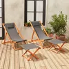 Two wooden deck chairs and two small tables are set up on a wooden deck. Produktbild-Vorschau