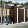 A garden shed with an attached open shelter, a bicycle, and gardening tools. Podgląd zdjęcia produktu