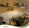 A dining room with a table and chairs, decorated with wall panels and shelves with plants and books. Podgląd zdjęcia produktu