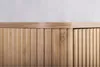 A close-up view of the top section of a wooden cabinet with vertical slats. Podgląd zdjęcia produktu