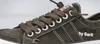 Close-up of a green sneaker with brown laces. Voir les images du produit